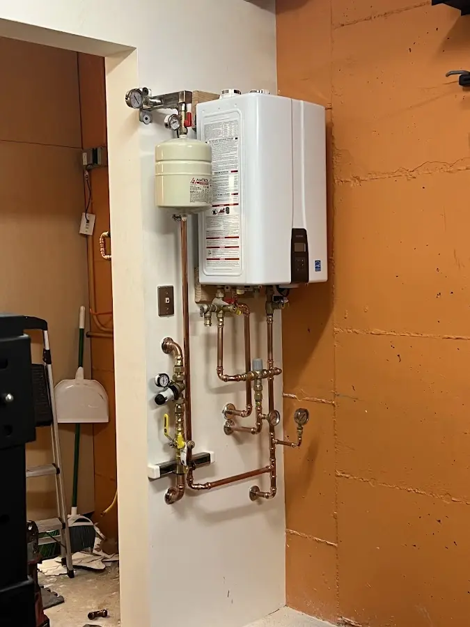 Plumbing technician inspecting water heater connections in Dublin